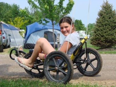 Child riding pedal kart at Jellystone Park™ South Haven campground