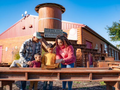 Family panning for gems at Old Faceful Mining Company at Jellystone Park™ South Haven
