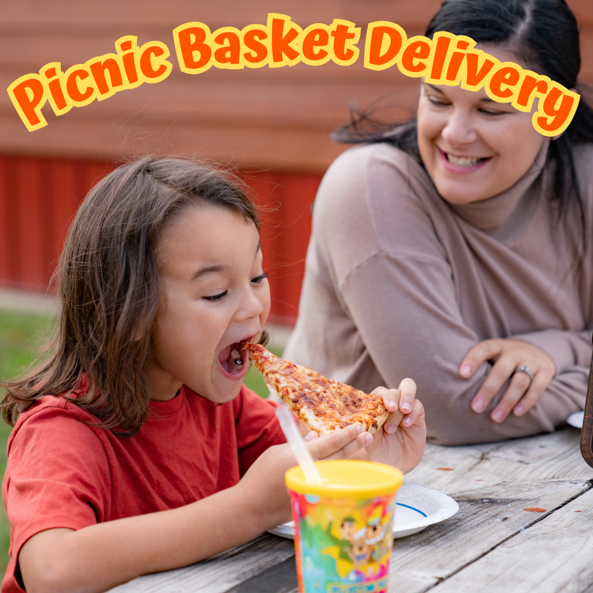 Child enjoying pizza from a picnic basket delivery at Jellystone Park South Haven