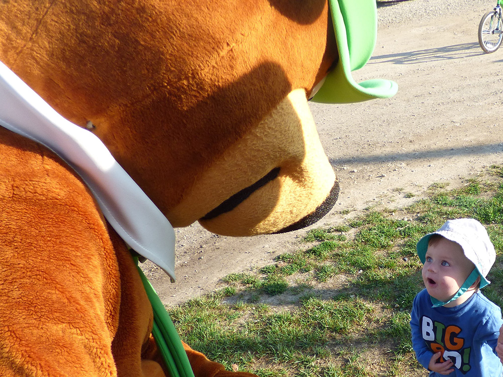 Yogi Bear surprising a young child during a campsite visit at Jellystone Park South Haven